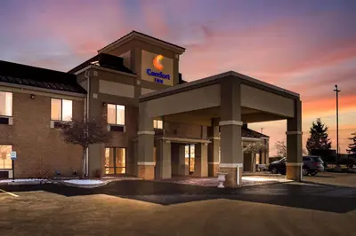 a hotel building with a sign on top of it at Comfort Inn Huntington Near University in Huntington