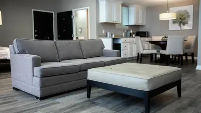 a living room with a couch and a table at Holiday Inn Wilmington by IHG in Gurneyville