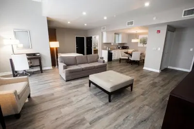 a living room with a couch and a table at Holiday Inn Wilmington by IHG in Gurneyville