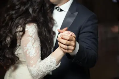 a bride and groom holding hands during their wedding ceremony at Holiday Inn Wilmington by IHG in Gurneyville