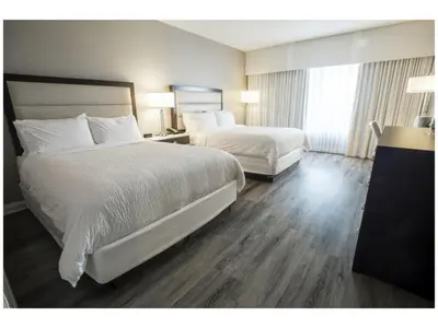a hotel room with two beds and a window at Holiday Inn Wilmington by IHG in Gurneyville