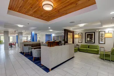 a lobby of a hospital with chairs and tables at Holiday Inn Express & Suites Shelbyville Indianapolis by IHG in Shelbyville