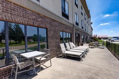 a row of chairs and tables outside of a building at Holiday Inn Express & Suites Shelbyville Indianapolis by IHG in Shelbyville