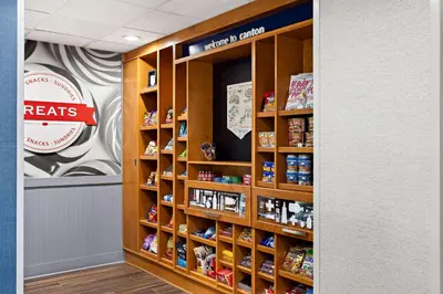 a store aisle with shelves with products on them at Hampton Inn & Suites Canton in North Canton
