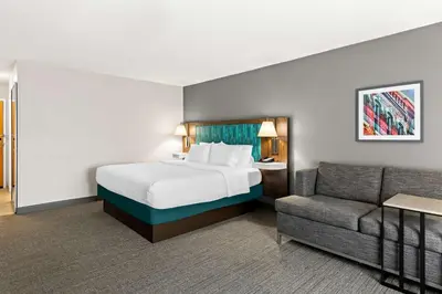 a hotel room with a bed and a couch at Hampton Inn & Suites Canton in North Canton