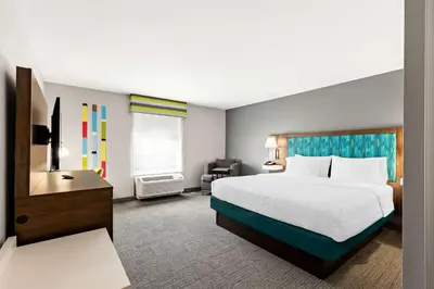 a hotel room with a large bed and a desk at Hampton Inn & Suites Canton in North Canton