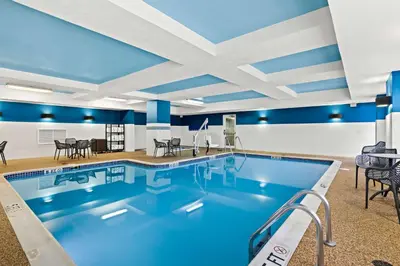 a pool in a hotel room with blue ceilings at Hampton Inn & Suites Canton in North Canton