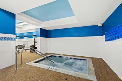 a hot tub in a room with blue and white walls at Hampton Inn & Suites Canton in North Canton