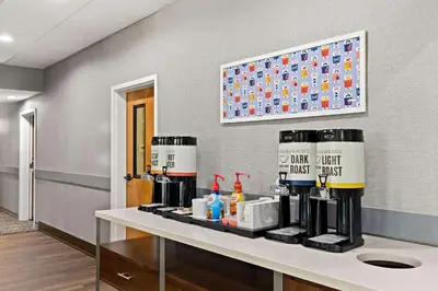 a room with a counter with a coffee maker on it at Hampton Inn & Suites Canton in North Canton