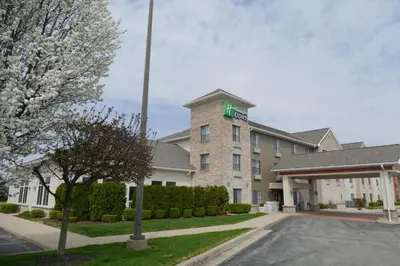 a building with a green cross on top of it at Holiday Inn Express Greensburg by IHG in Greensburg