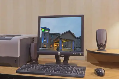 a computer monitor and a keyboard and mouse on a desk at Holiday Inn Express Greensburg by IHG in Greensburg