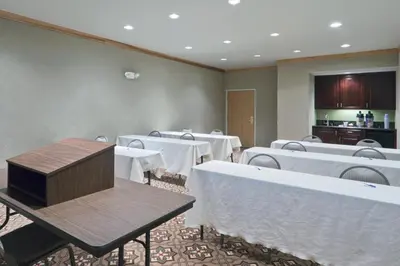 a conference room with tables and white table cloth at Holiday Inn Express Greensburg by IHG in Greensburg