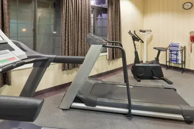 a gym with two exercise bikes and a treadmill at Holiday Inn Express Greensburg by IHG in Greensburg