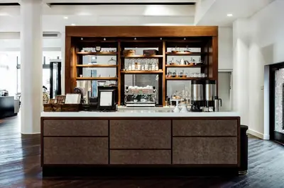 a bar in a room with a counter at Hotel Covington Cincinnati Riverfront in Covington