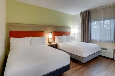 a hotel room with two beds and a window at Candlewood Suites Lexington by IHG in Lexington