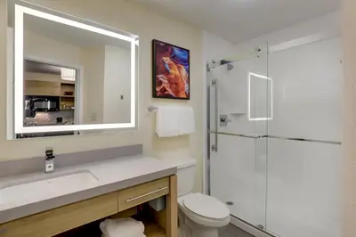 a bathroom with a toilet and a sink and a shower at Candlewood Suites Lexington by IHG in Lexington