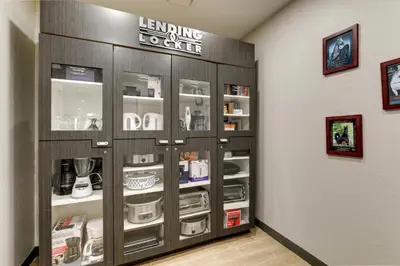 a display cabinet in a room with products in it at Candlewood Suites Lexington by IHG in Lexington