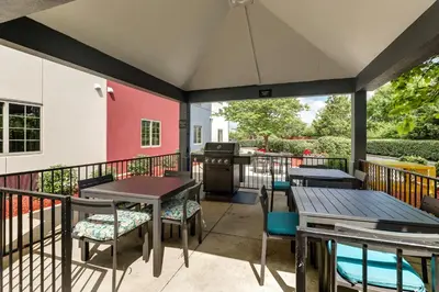 a patio with tables and chairs and a grill at Candlewood Suites Lexington by IHG in Lexington