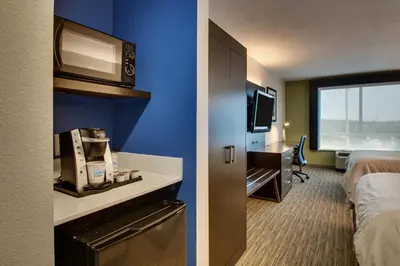 a hotel room with a bedroom with a bed and a tv at Holiday Inn Express Georgetown by IHG in Georgetown