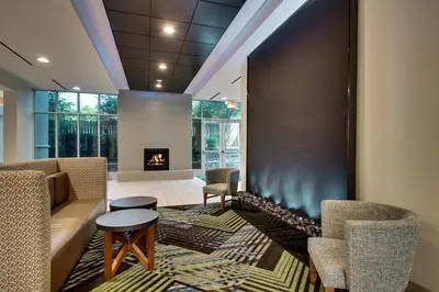 a living room with a couch and chairs and a fireplace at Holiday Inn Express Georgetown by IHG in Georgetown