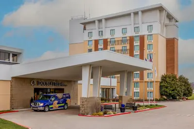 a blue car parked in front of a building at DoubleTree by Hilton Cincinnati Airport in Hebron