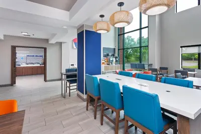 a dining room with a long table and blue chairs at Holiday Inn Express Hotel & Suites Youngstown - North Lima/Boardman by IHG in North Lima