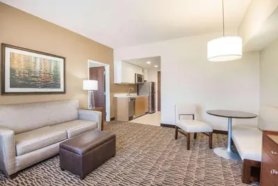a living room with a couch and a table at Hawthorn Extended Stay by Wyndham Saint Clairsville in Saint Clairsville