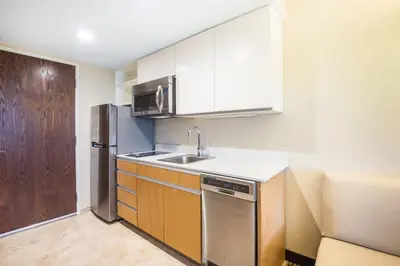 a kitchen with a sink and a refrigerator at Hawthorn Extended Stay by Wyndham Saint Clairsville in Saint Clairsville
