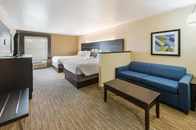 a hotel room with a bed and a couch at Holiday Inn Express London-I-70 by IHG in London