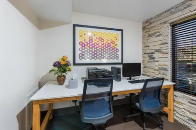 an office with a desk with two chairs and a computer at Holiday Inn Express London-I-70 by IHG in London