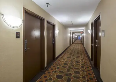 a corridor of a hospital hallway with doors and a carpet at Red Roof Inn & Suites Cincinnati North-Mason in Mason