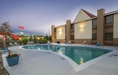 a swimming pool in front of a hotel at Red Roof Inn & Suites Cincinnati North-Mason in Mason