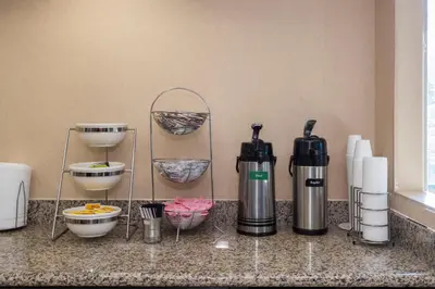 a counter with a coffee maker and other kitchen items at Red Roof Inn & Suites Cincinnati North-Mason in Mason