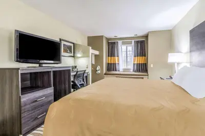a hotel room with a large bed and a flat screen tv at Quality Inn & Suites North Lima - Boardman in North Lima