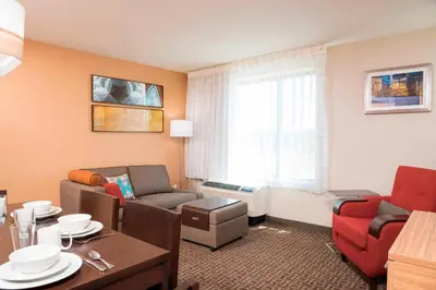 a living room with a couch and a table in a room at TownePlace Suites by Marriott Ontario-Mansfield in Mansfield