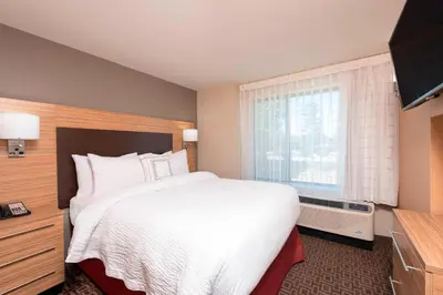 a hotel room with a large bed and a window at TownePlace Suites by Marriott Ontario-Mansfield in Mansfield