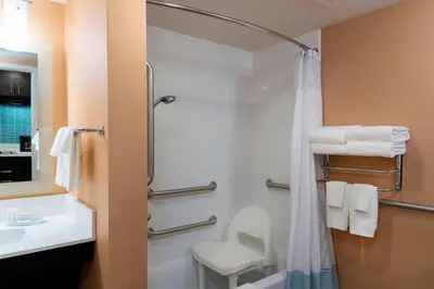 a bathroom with a shower and a toilet and a sink at TownePlace Suites by Marriott Ontario-Mansfield in Mansfield