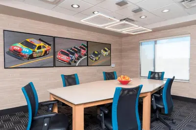 a conference room with a table and blue chairs at TownePlace Suites by Marriott Ontario-Mansfield in Mansfield