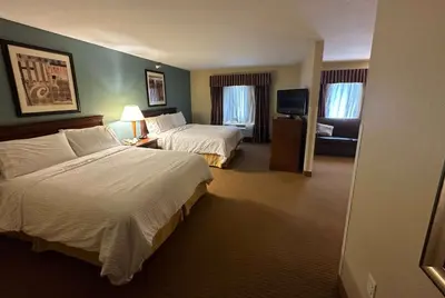 a hotel room with two beds and a television at Wingate by Wyndham Newell in Newell