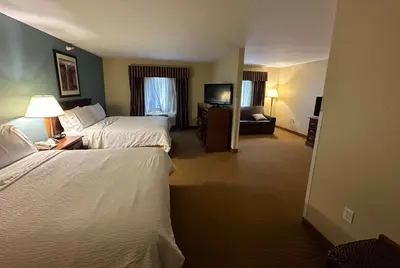 a hotel room with two beds and a television at Wingate by Wyndham Newell in Newell