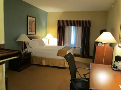 a hotel room with a bed and a desk at Wingate by Wyndham Newell in Newell