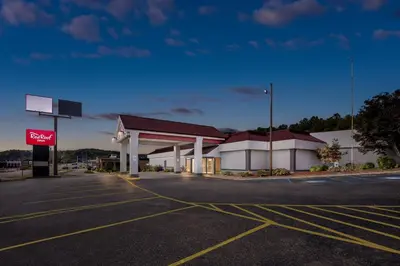 an empty parking lot in front of a gas station at Red Roof Inn Cambridge, OH in Cambridge