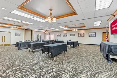 a large room with tables and chairs in it at Red Roof Inn Cambridge, OH in Cambridge