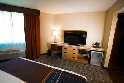 a hotel room with a bed and a flat screen tv at Sawmill Creek by Cedar Point Resorts in Sandusky
