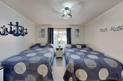 a bedroom with two beds and a window at Put-in-Bay Island Club #5 in Put-in-Bay