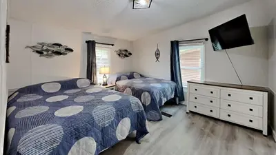 a bedroom with two beds and a flat screen tv at Put-in-Bay Island Club #13 in Put-in-Bay