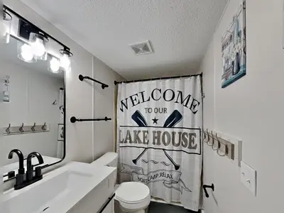 a bathroom with a sink and a toilet and a shower curtain at Put-in-Bay Island Club #13 in Put-in-Bay