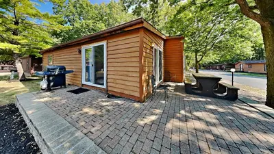 a small cabin with a grill on a brick patio at Put-in-Bay Island Club #51 in Put-in-Bay