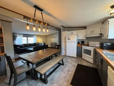 a kitchen and living room with a wooden table in a room at Put-in-Bay Island Club #71 in Put-in-Bay