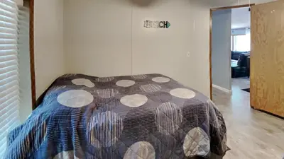 a bedroom with a bed with a patterned comforter at Put-in-Bay Island Club #71 in Put-in-Bay